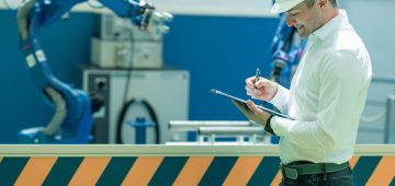 Technology Engineer Working in Factory. Holding check-list and supervising